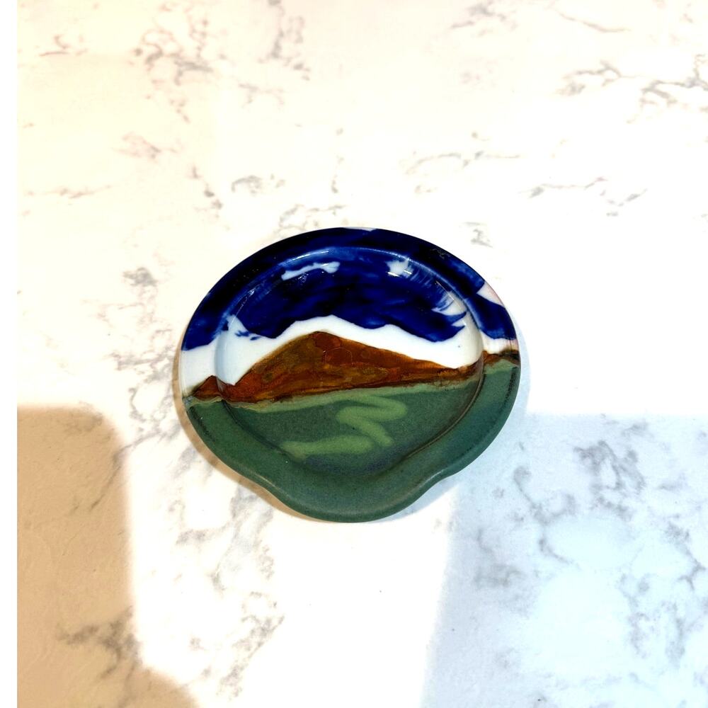 handcrafted ceramic spoon rest mountain green foreground blue sky signed